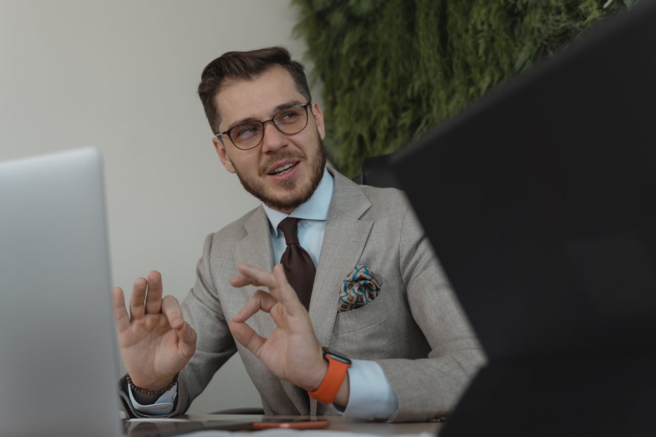 Professional businessman engaging in a discussion at his workplace, conveying confidence and leadership.